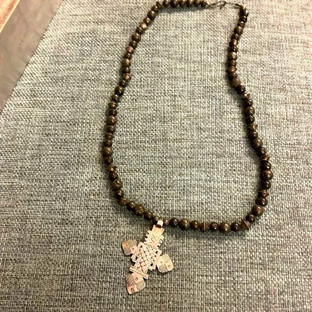 This unique vintage necklace features a handmade Ethiopian cross pendant.